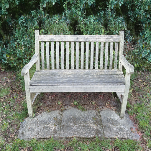 A photograph of a memorial bench which has been generated using artificial intelligence.