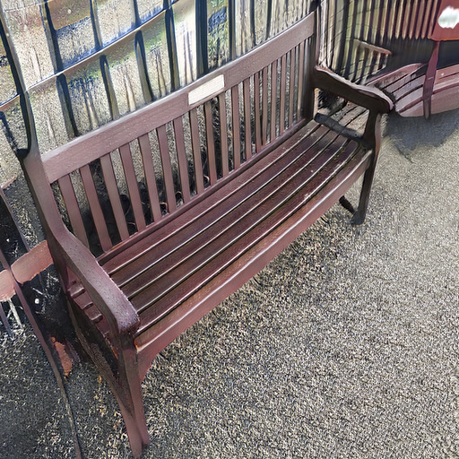 A photograph of a memorial bench which has been generated using artificial intelligence.