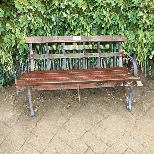 A photograph of a memorial bench which has been generated using artificial intelligence.