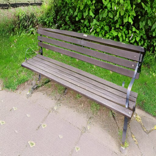 A photograph of a memorial bench which has been generated using artificial intelligence.
