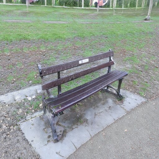 A photograph of a memorial bench which has been generated using artificial intelligence.