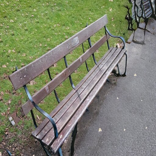 A photograph of a memorial bench which has been generated using artificial intelligence.