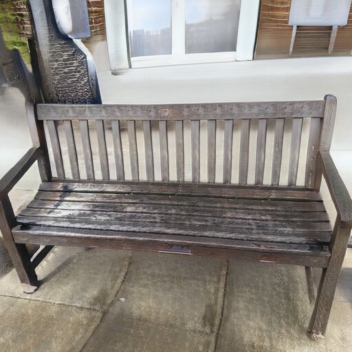 A photograph of a memorial bench which has been generated using artificial intelligence.