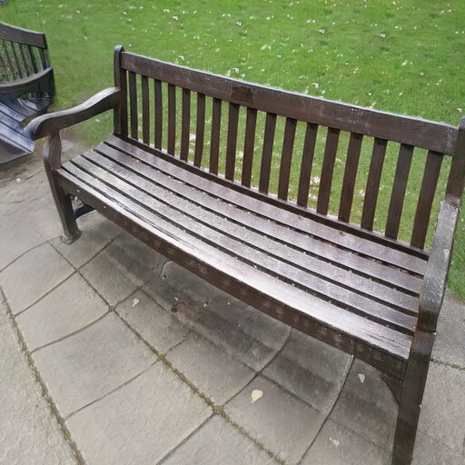 A photograph of a memorial bench which has been generated using artificial intelligence.
