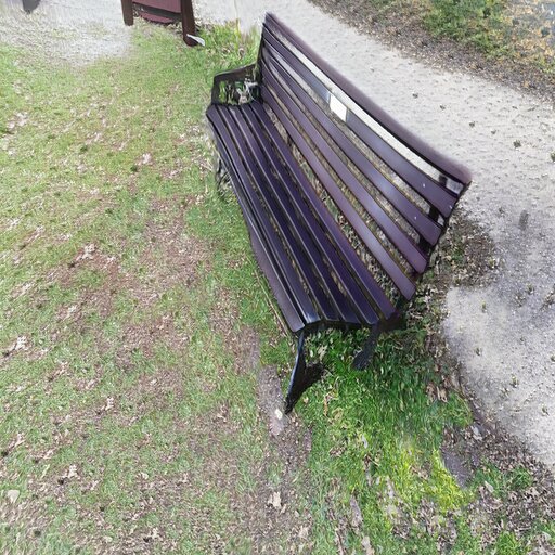 A photograph of a memorial bench which has been generated using artificial intelligence.