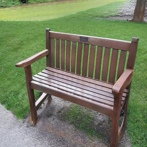 A photograph of a memorial bench which has been generated using artificial intelligence.