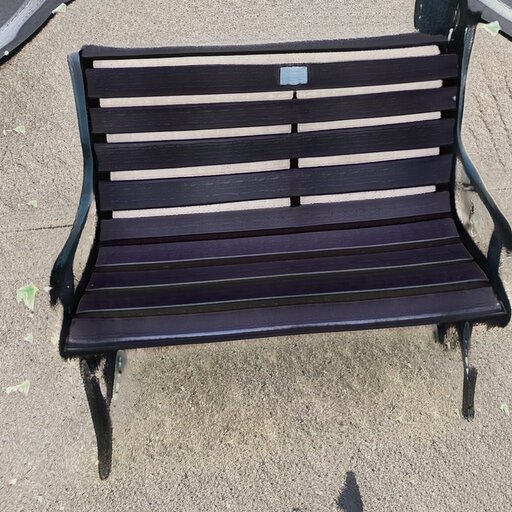 A photograph of a memorial bench which has been generated using artificial intelligence.